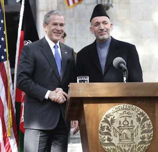 Pesident George W. Bush and President Hamid Karzai of Afghanistan appear together in 2006 at a joint news conference at the Presidential Palace in Kabul