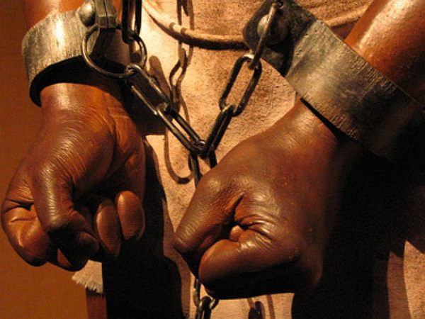 Negro slave, hands, feet and neck in chains