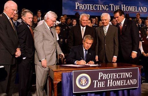 George Bush signs the mandate empowering the Department of Homeland Security
