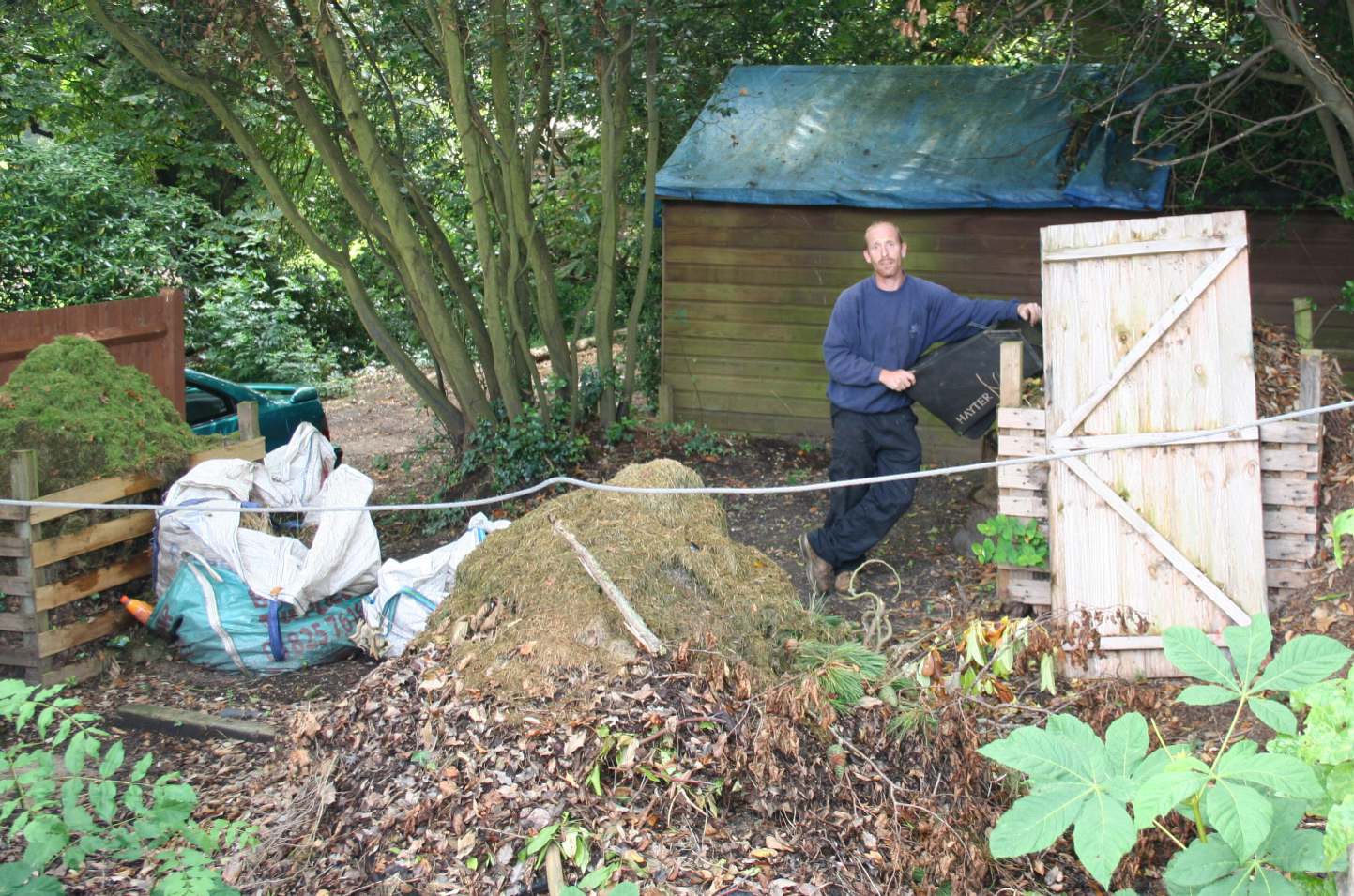 Russell Pike, owner of manager of Perfect Gardens, and the bonfire turned dump