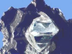 Misshapen octahedral rough diamond crystal in matrix