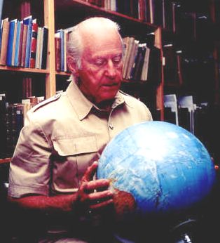 Thor Heyerdal exploring a small globe in his office