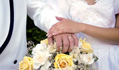 Wedding vows joined hands and bouquet of flowers 