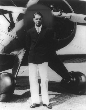 Howard Hughes standing in front of a Boeing Army Pursuit Plane, , .