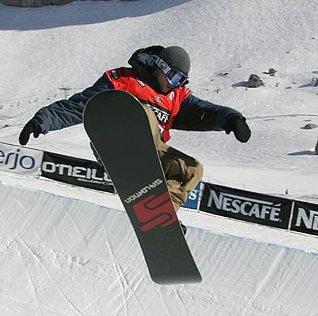 Snowboarder in half-pipe turn