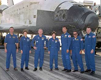 The STS-114 crew stands in front of Discovery at Edwards Air Force Base.