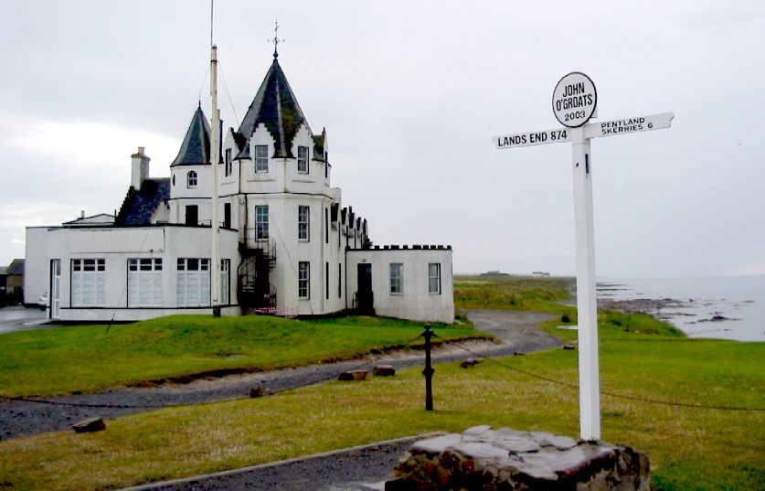 Signpost pointing to Lands End, with John O'Groats hotel in the background