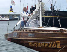 Horie at the bow of his small boat, the Mermaid III.