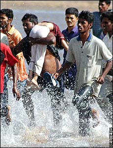 Rescuers carry girl from ocean