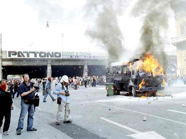 Protesters try to stop members of the G8 from attending the summit during the 27th G8 summit in Genoa, Italy by burning vehicles on the main route to the summit