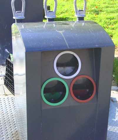 Glass waste collection point in a neighborhood area for separating clear, green and amber glass - bottle bank