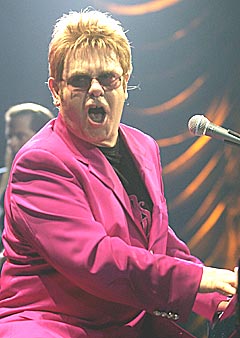 Elton John performing in pink jacket