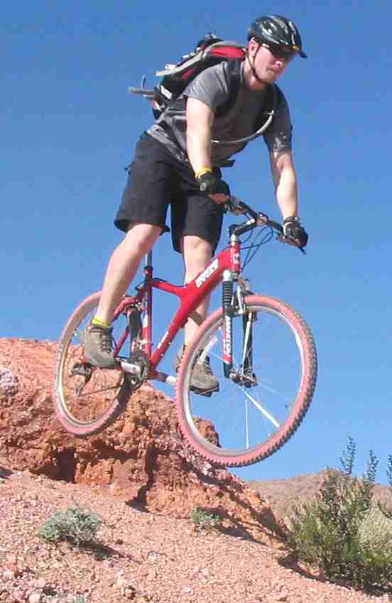 Mountain biking rough going grabs air