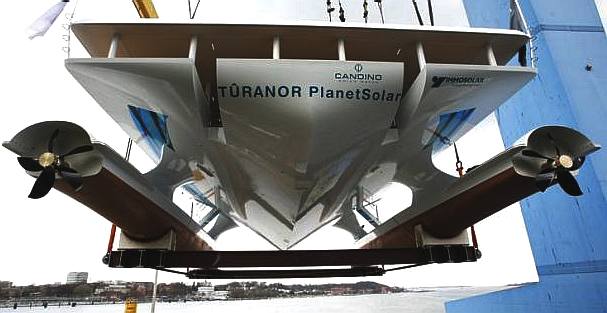 Tranor PlanetSolar is crane hoisted from dry dock